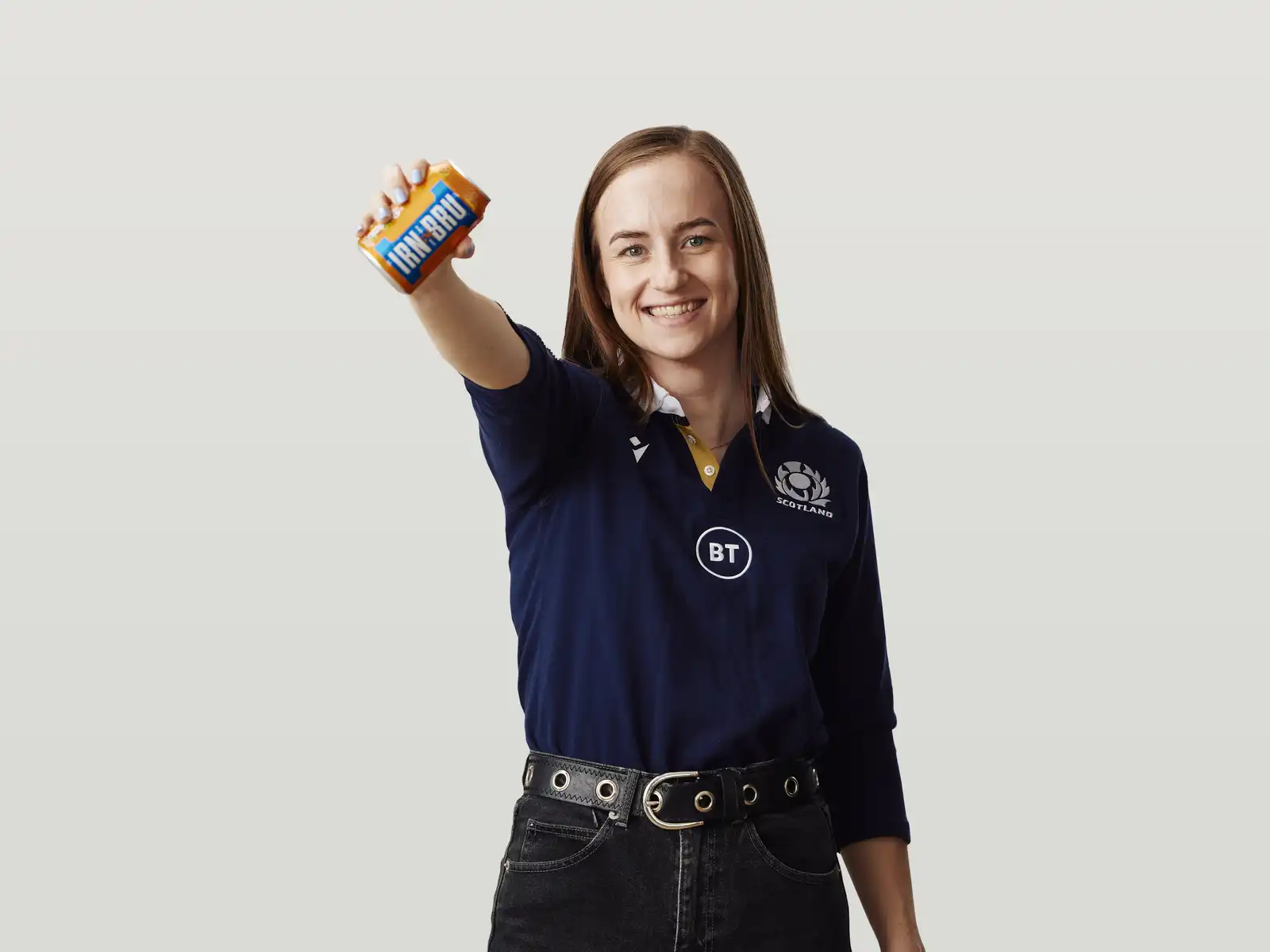 Sarah F wearing a Scotland rugby jersey and holding up a can of Irn Bru
