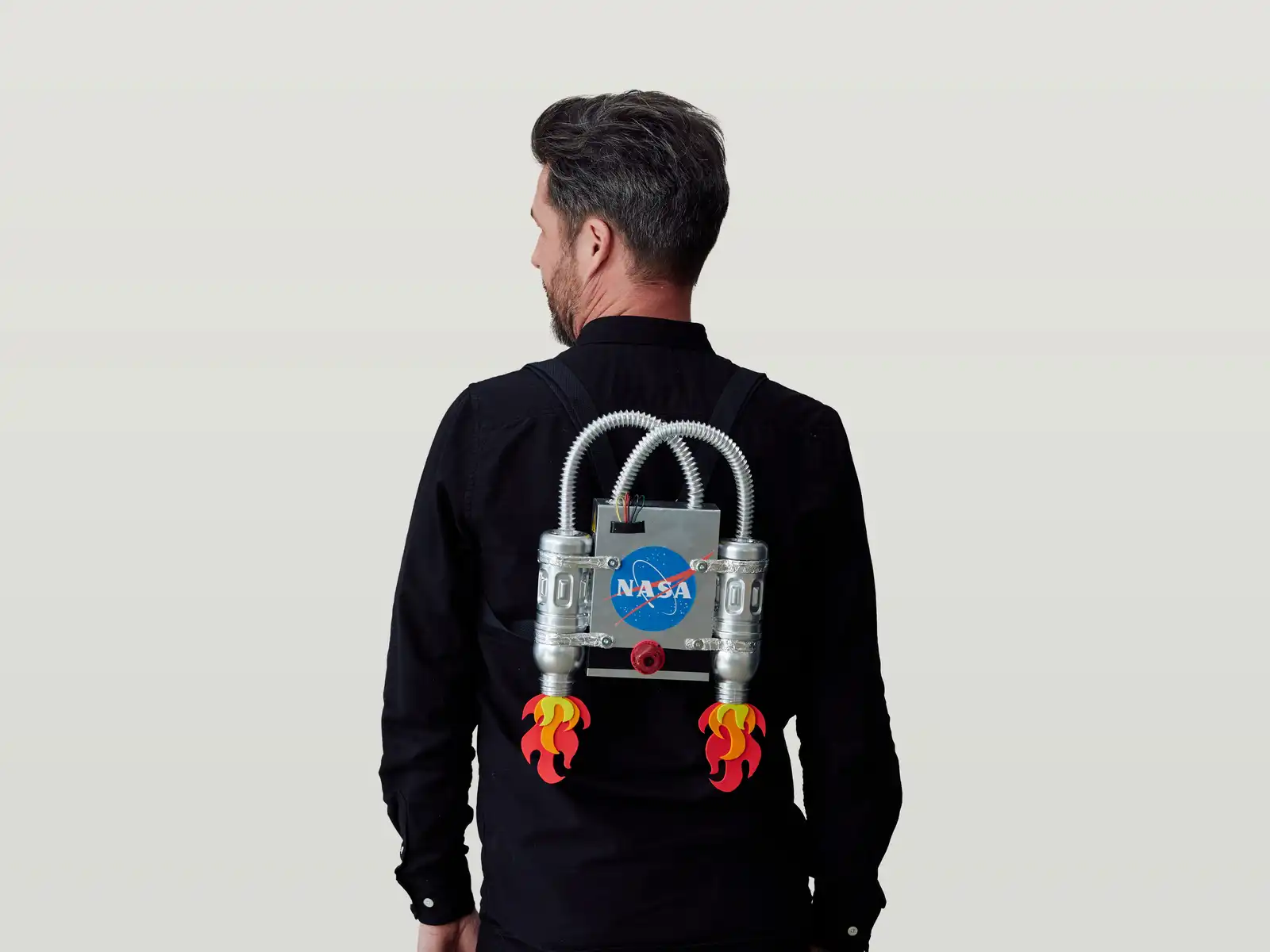 Shane with back to camera wearing a Nasa jetpack