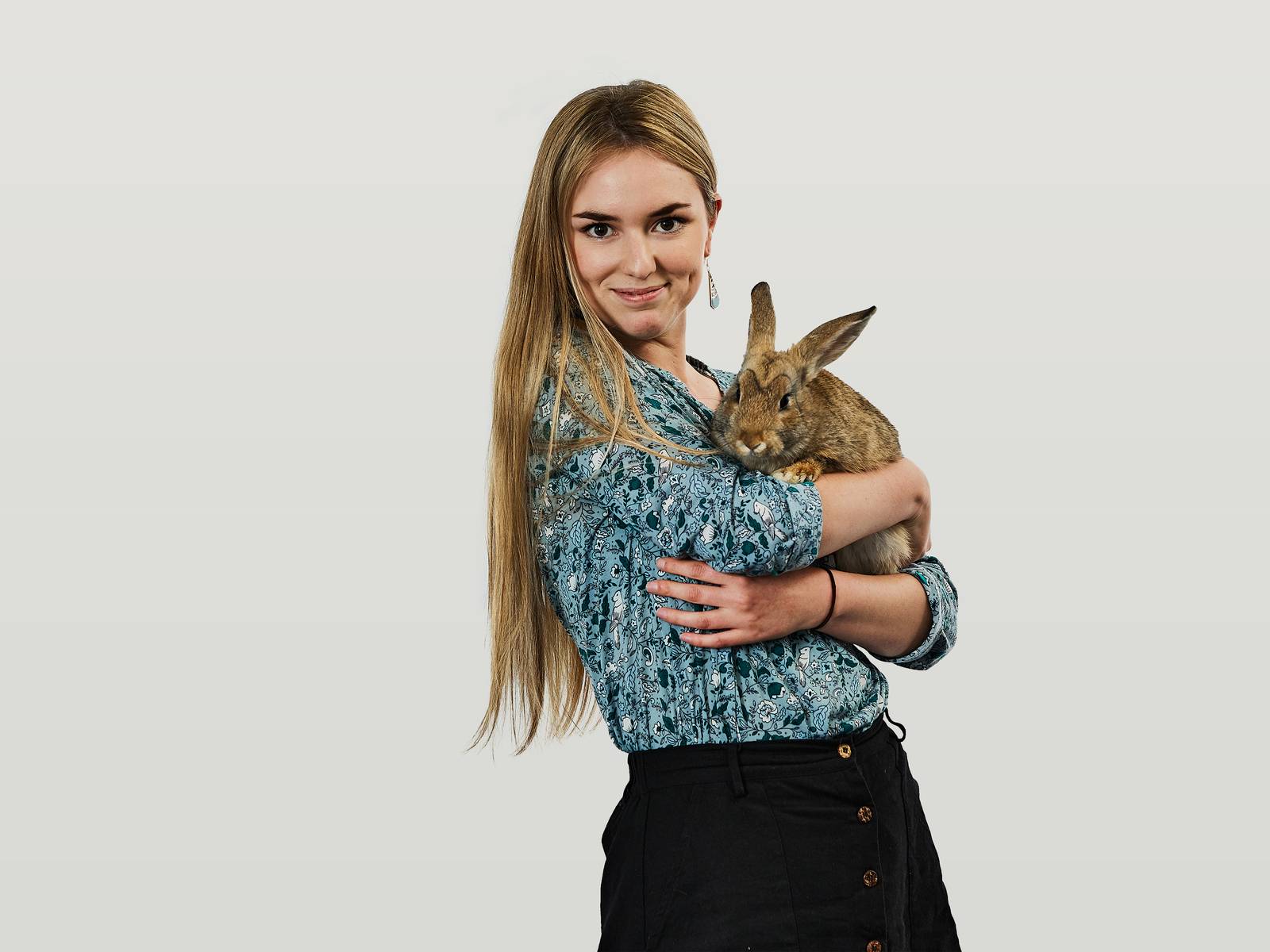 Usha holding her pet rabbit