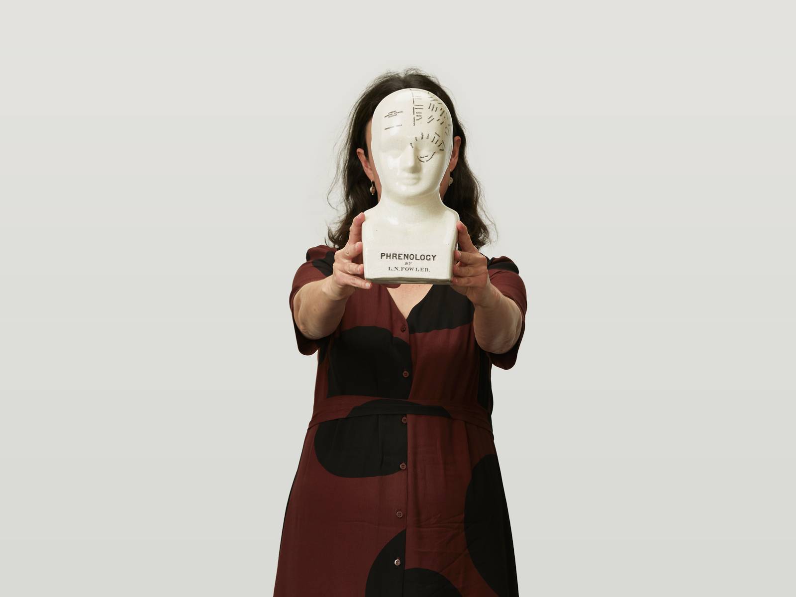 Virginia holding up a ceramic head.