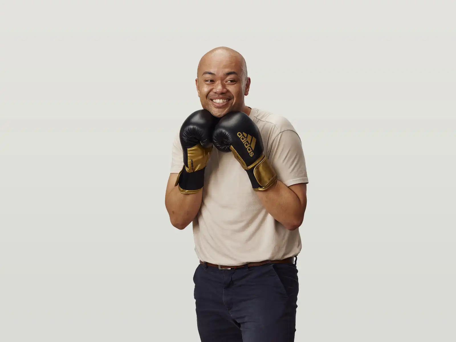 Wilson in a white shirt wearing boxing gloves